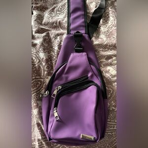 Purple cross body saddle bag.